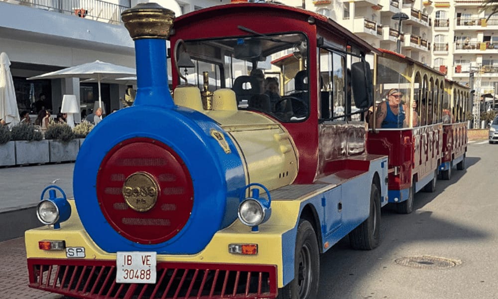 a blue, red and yellow road train parked