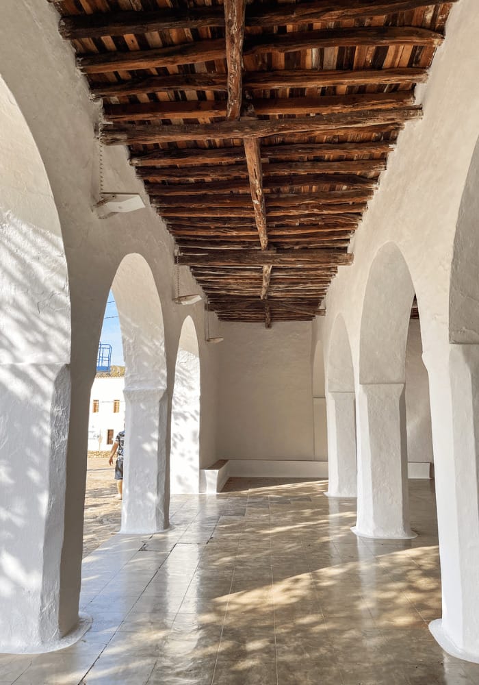 Wooden ceiling of a white Spanish church with archway walls